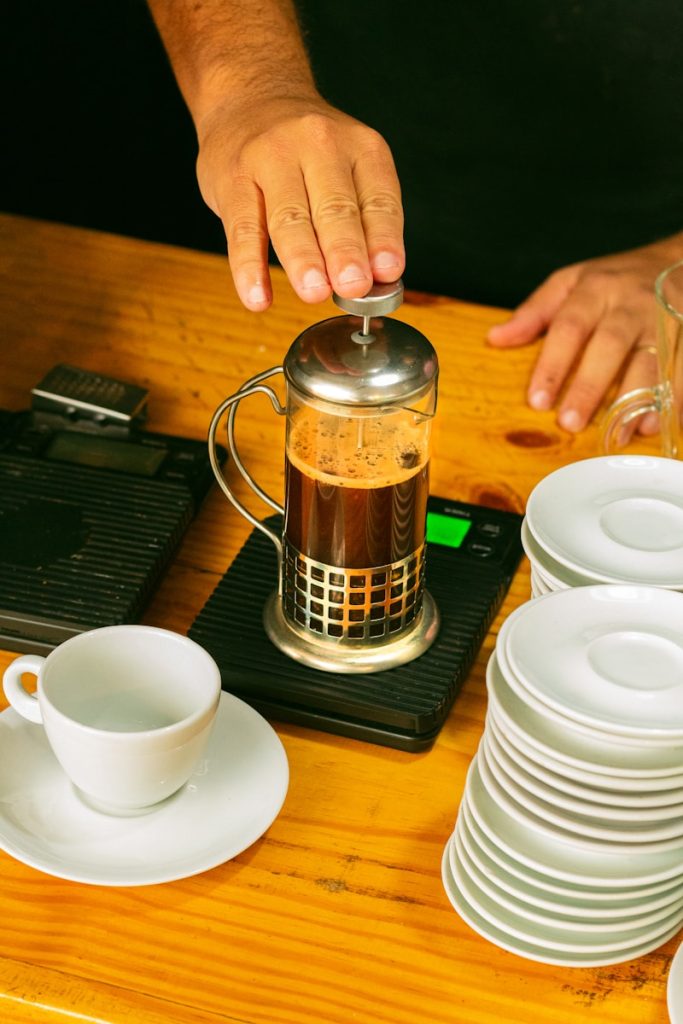 a person pours coffee into a coffee pot brazil